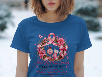 Blue t-shirt with holiday wreath, pink ribbon, and text "Hope Lights the Season."