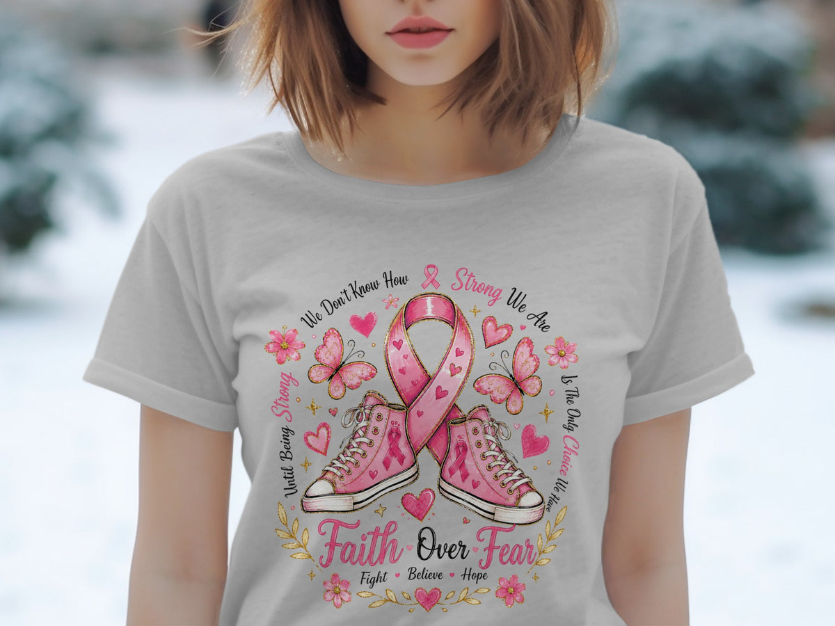 T-shirt with pink breast cancer ribbon, sneakers, butterflies, and text "Faith Over Fear".