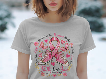 T-shirt with pink breast cancer ribbon, sneakers, butterflies, and text "Faith Over Fear".