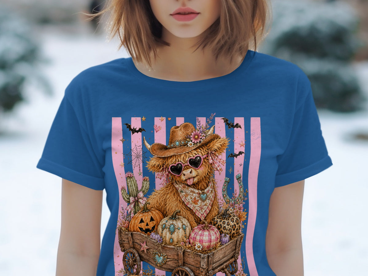 Cow with sunglasses in wagon full of pumpkins, bats, and cacti on striped background.