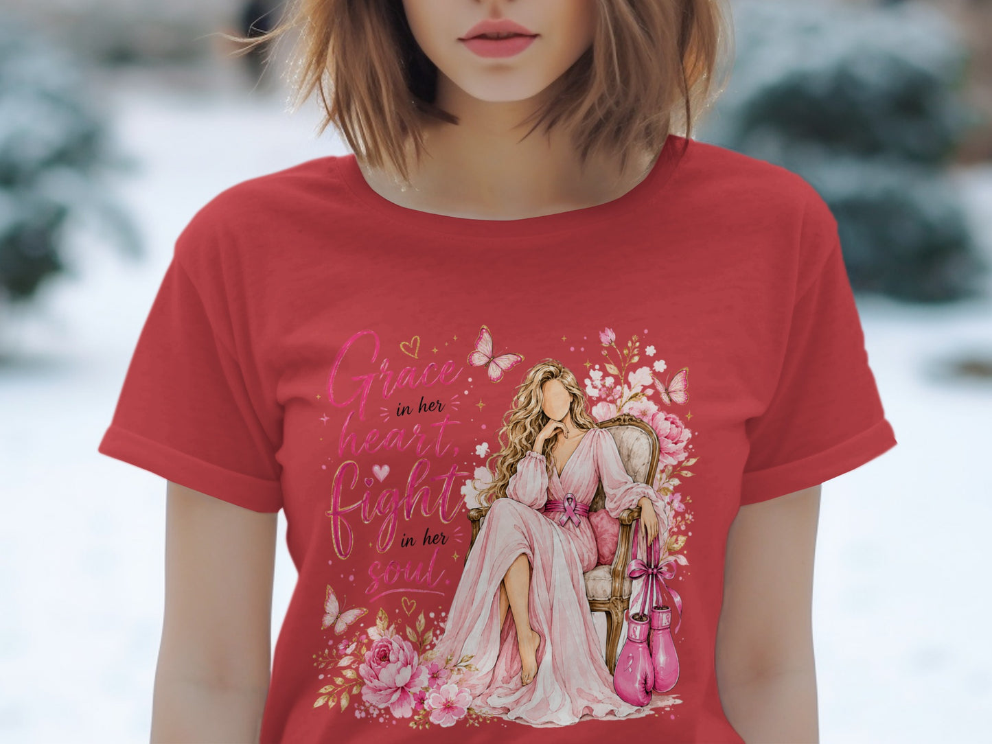 Red t-shirt with watercolor art of a woman sitting, boxing gloves, and text "Grace in her heart, Fight in her soul."