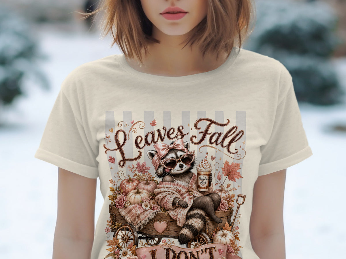 Raccoon in wagon with pumpkins, holding coffee, "Leaves Fall" text.