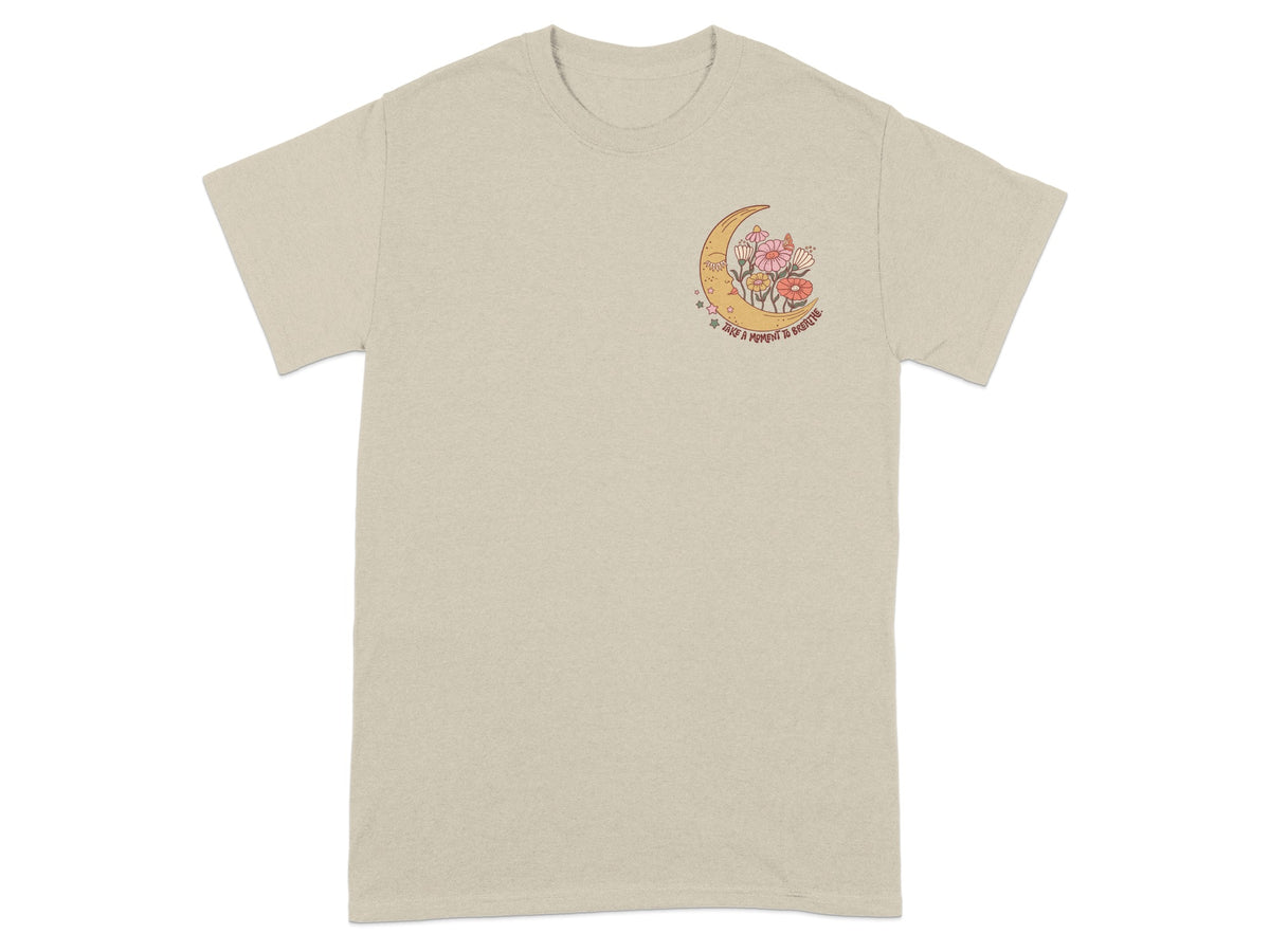 T-shirt with crescent moon, flowers, stars, and text reading "Take a moment to breathe."