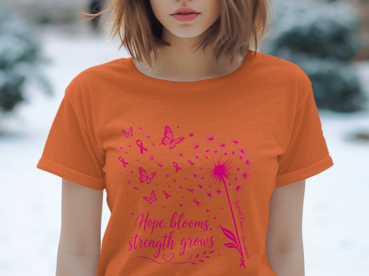 Orange t-shirt with pink dandelion, butterflies, and "Hope blooms, strength grows" text.
