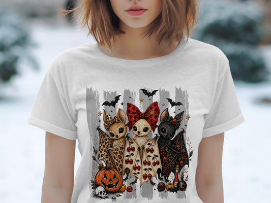 Three cartoon bats with Halloween decorations stand in front of gray stripes.