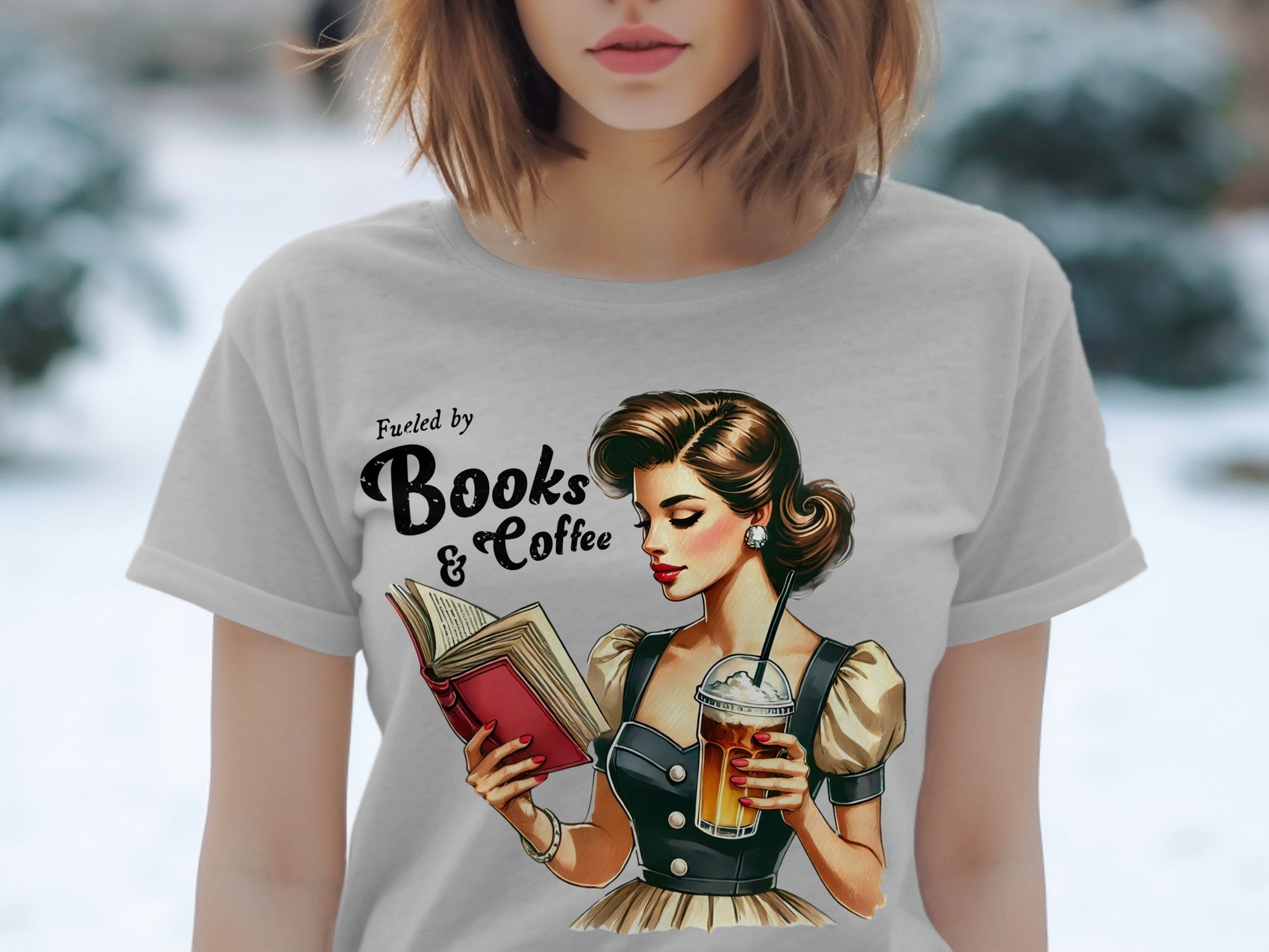 T-shirt graphic of a woman reading and drinking coffee, with text "Fueled by Books & Coffee."