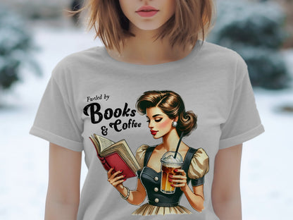 T-shirt graphic of a woman reading and drinking coffee, with text "Fueled by Books & Coffee."