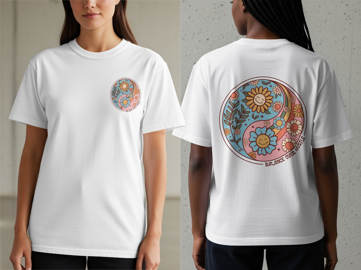 White t-shirt with a retro yin yang design featuring smiling flowers and the text "BALANCE OVER HUSTLE".