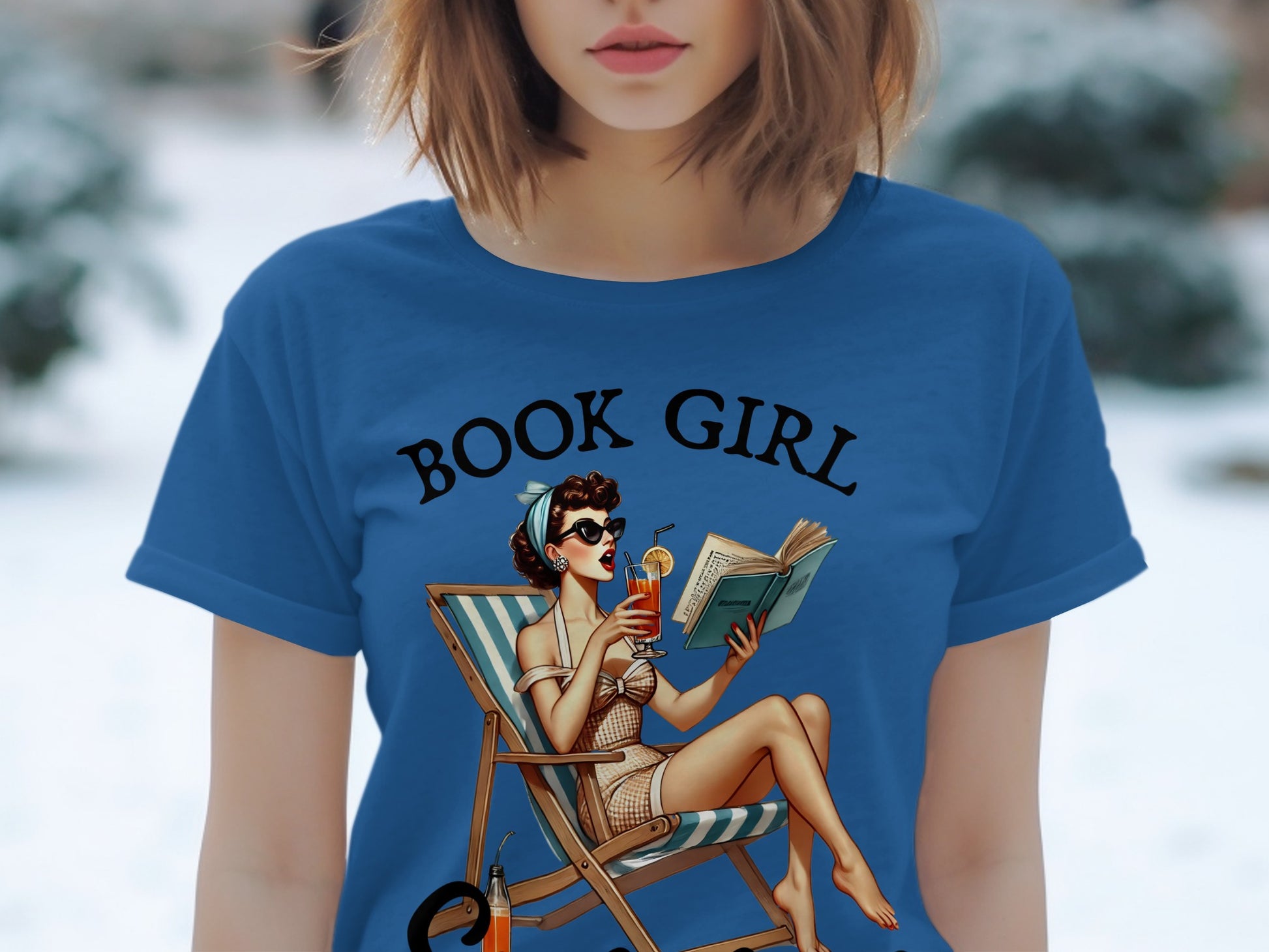 Blue t-shirt with "BOOK GIRL" text and retro pin-up girl reading in a beach chair.