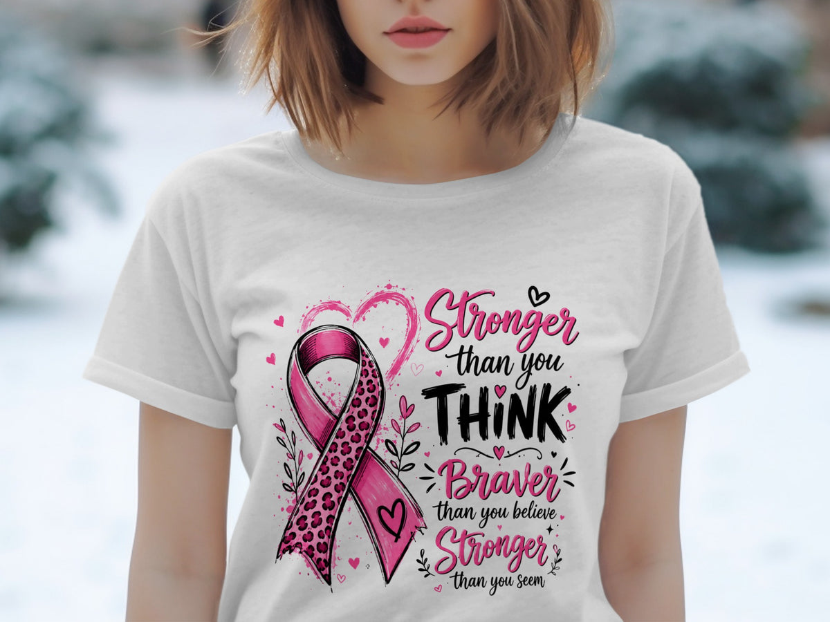 White t-shirt with pink ribbon art and text: Stronger than you THINK, Braver than you believe, Stronger than you seem.