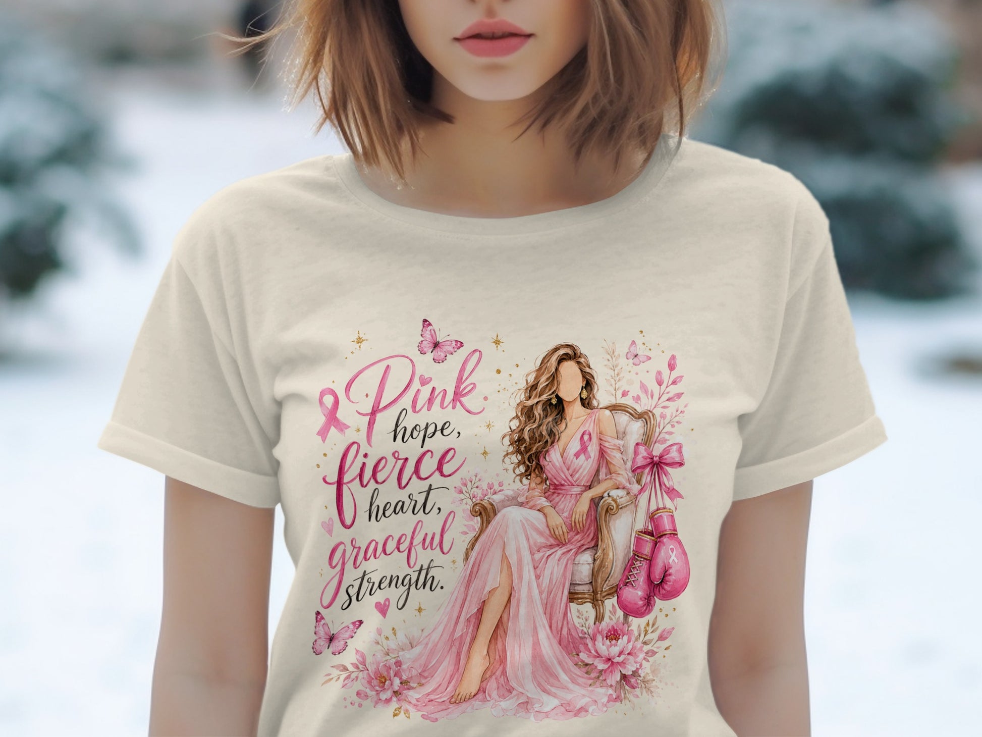 Shirt with illustration of woman, pink ribbons, boxing gloves, and text "Pink hope, fierce heart, graceful strength."