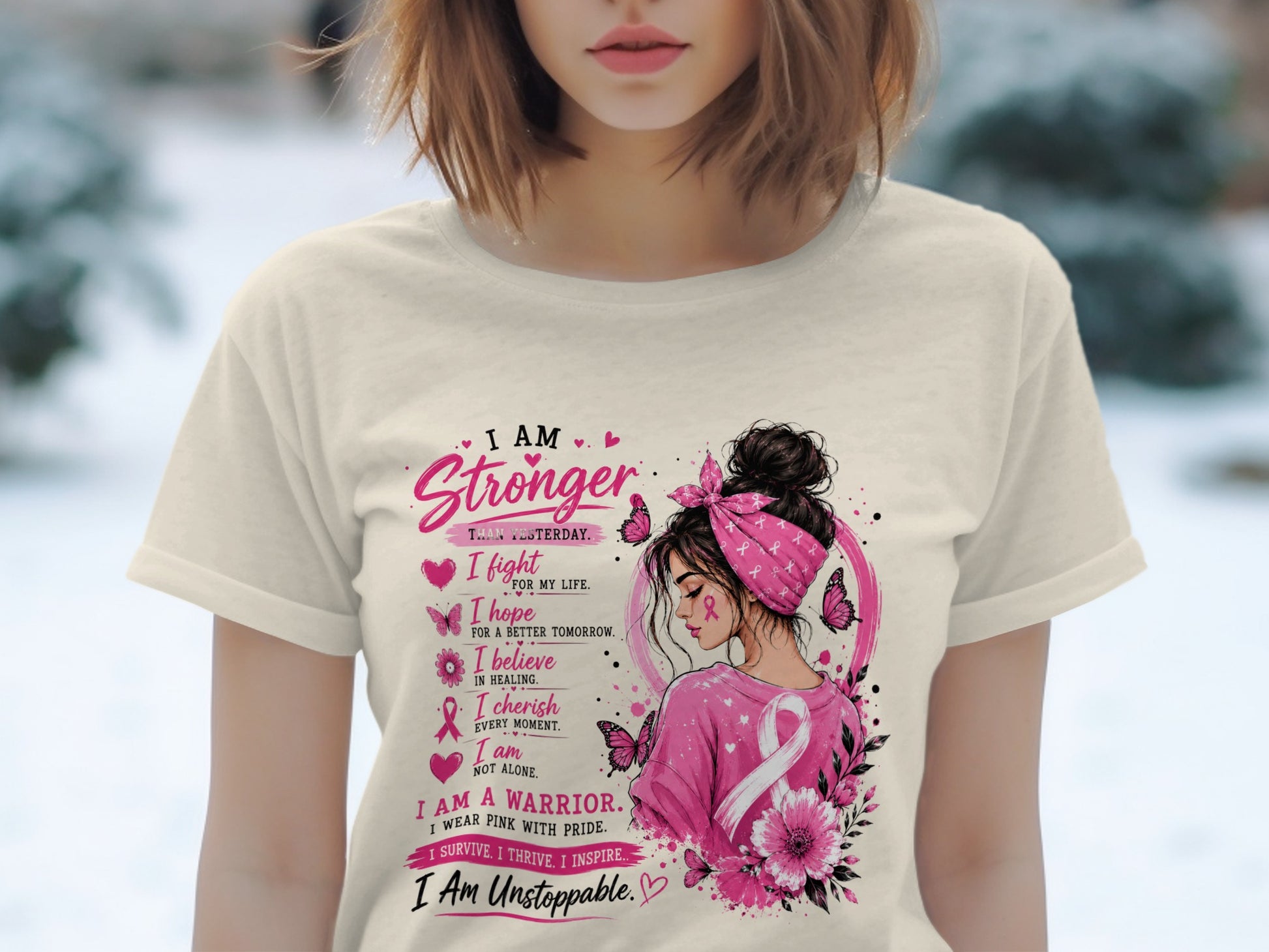 Cream t-shirt with pink breast cancer awareness graphic of woman and inspirational text.