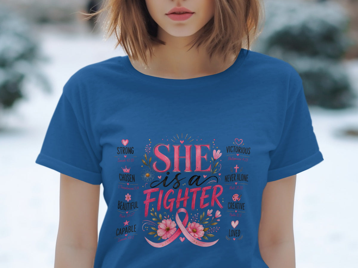 Blue t-shirt with "SHE is a FIGHTER" and affirmations, featuring a pink ribbon and flowers.