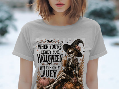 Skeleton witch with drink and text "When You're Ready for Halloween But It's Only July".