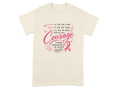 Cream t-shirt with pink text and a pink ribbon: "Courage looks beautiful on every fighter."