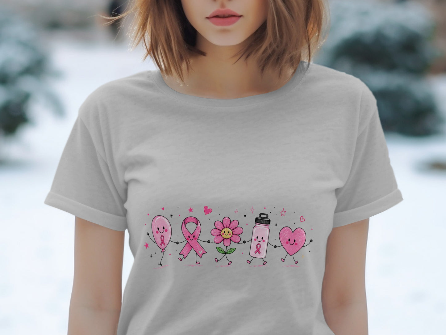 Gray t-shirt with cartoon pink balloon, ribbon, flower, water bottle, and heart holding hands.