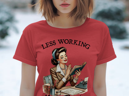 Red t-shirt with "Less Working" text and vintage woman reading at desk.