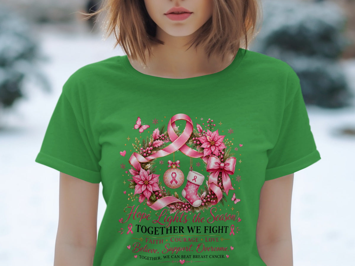 Green t-shirt with wreath graphic, pink ribbon, and text "Hope Lights the Season TOGETHER WE FIGHT".
