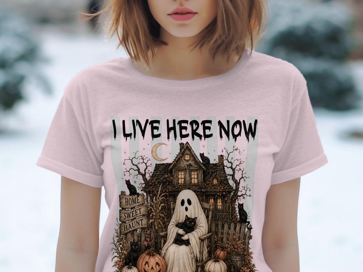 Ghost with cat on shirt reads "I LIVE HERE NOW" with haunted house and black cats.