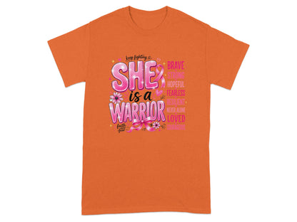 Orange t-shirt with text "She is a Warrior" and inspirational words.