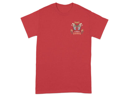 Red t-shirt with a colorful butterfly graphic and text "TRUST YOUR VISIONS".