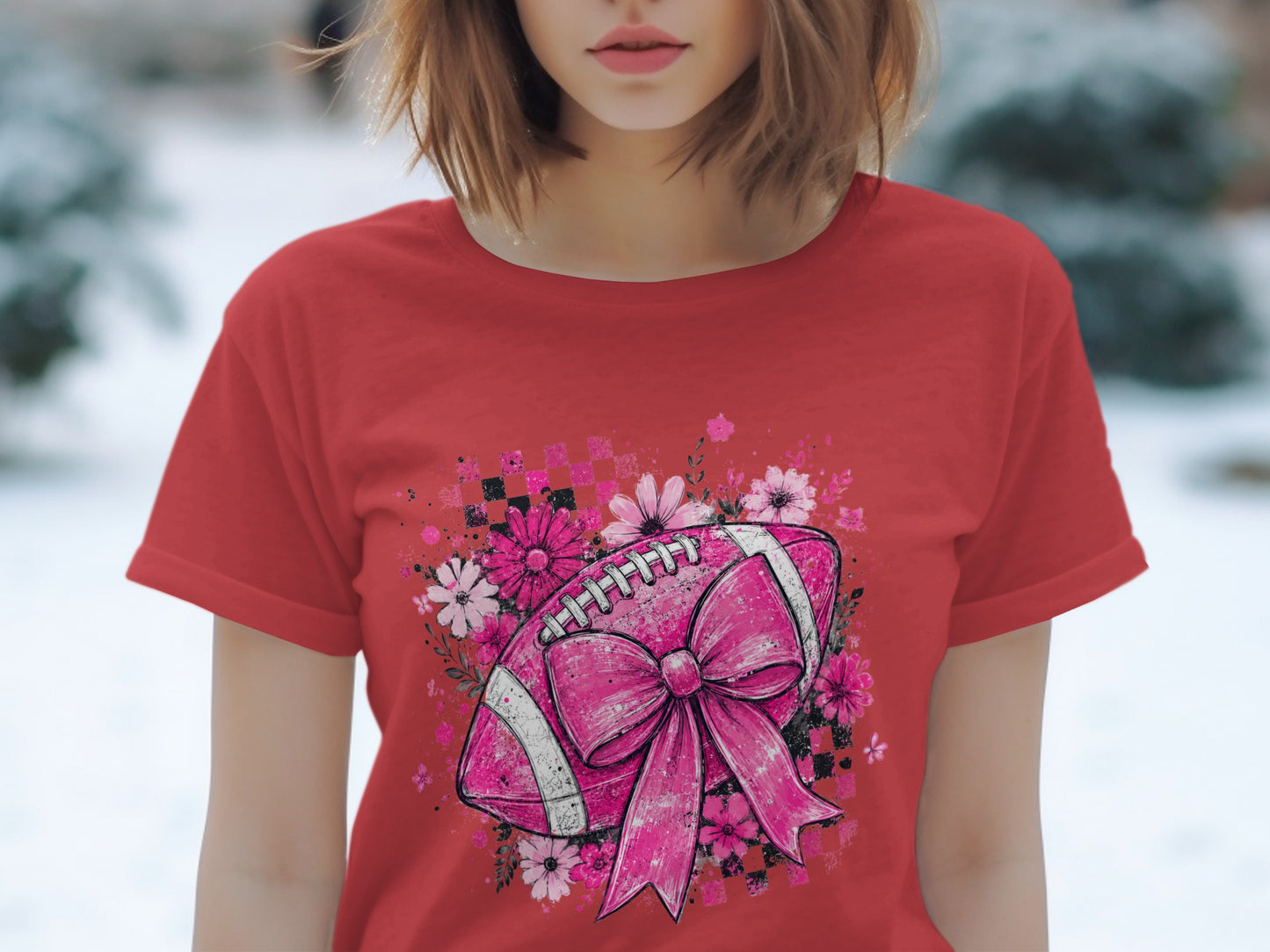 Red t-shirt with a pink football design, bow, and flowers.