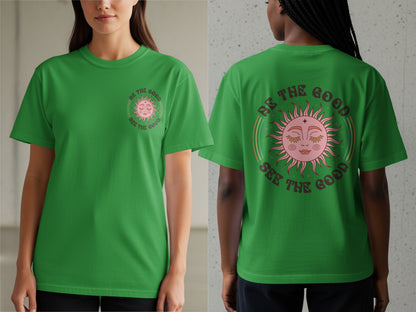 Green t-shirt with a sun graphic and "Be the good see the good" text.