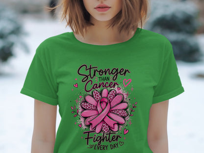 Green t-shirt with "Stronger Than Cancer Fighter Every Day" text and pink ribbon flower.