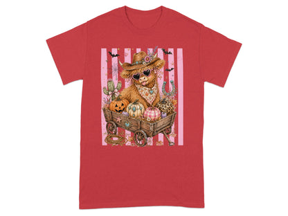 Highland cow in cowboy hat with heart sunglasses in wagon with pumpkins and bats.