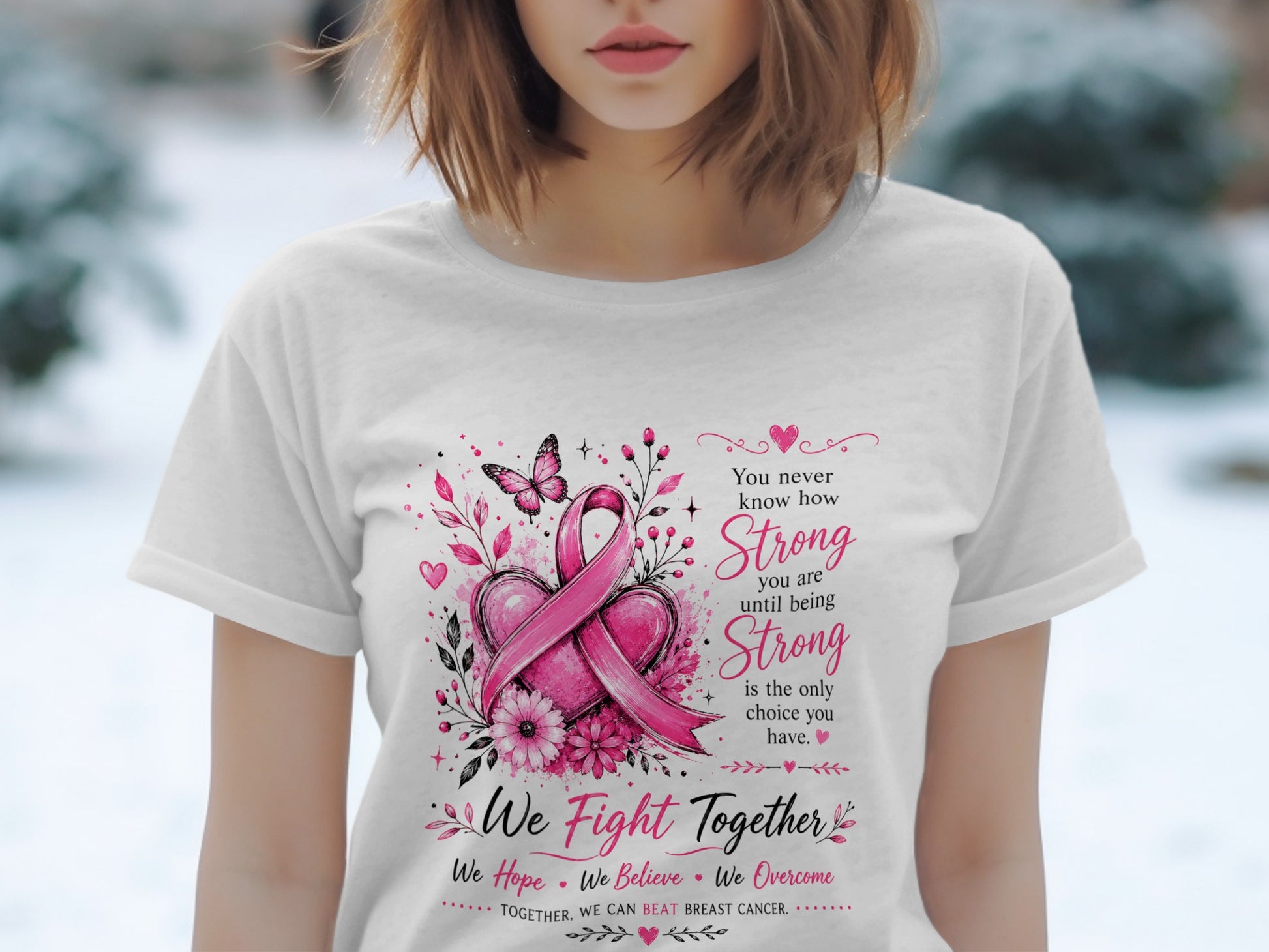 White t-shirt with pink breast cancer ribbon, hearts, flowers, and inspirational text.