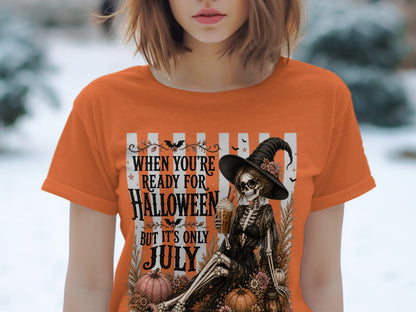 Orange t-shirt with skeleton, pumpkins, and text "When you're ready for Halloween but it's only July."