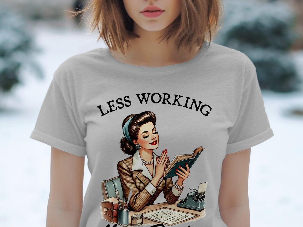 T-shirt with illustration of woman reading, "LESS WORKING" text.