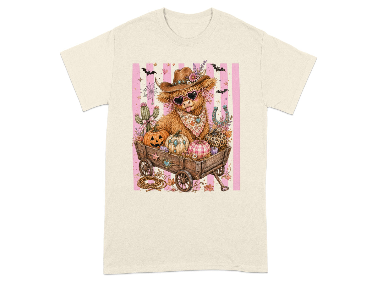 Cow wearing heart sunglasses and cowboy hat in a wagon with pumpkins and flowers.