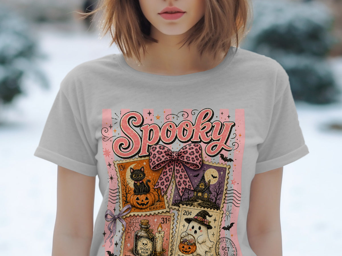 Light gray t-shirt with a "Spooky" Halloween graphic featuring postage stamps of a black cat, haunted house, potion, and ghost.