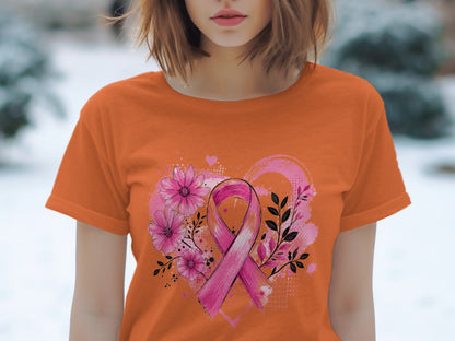 Orange t-shirt with pink ribbon, flowers, and heart design.