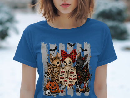 Three cute cartoon bats with Halloween decorations, centered on a blue t-shirt.