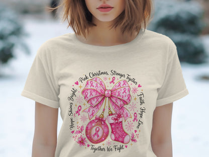 T-shirt with a pink ribbon Christmas design and text.