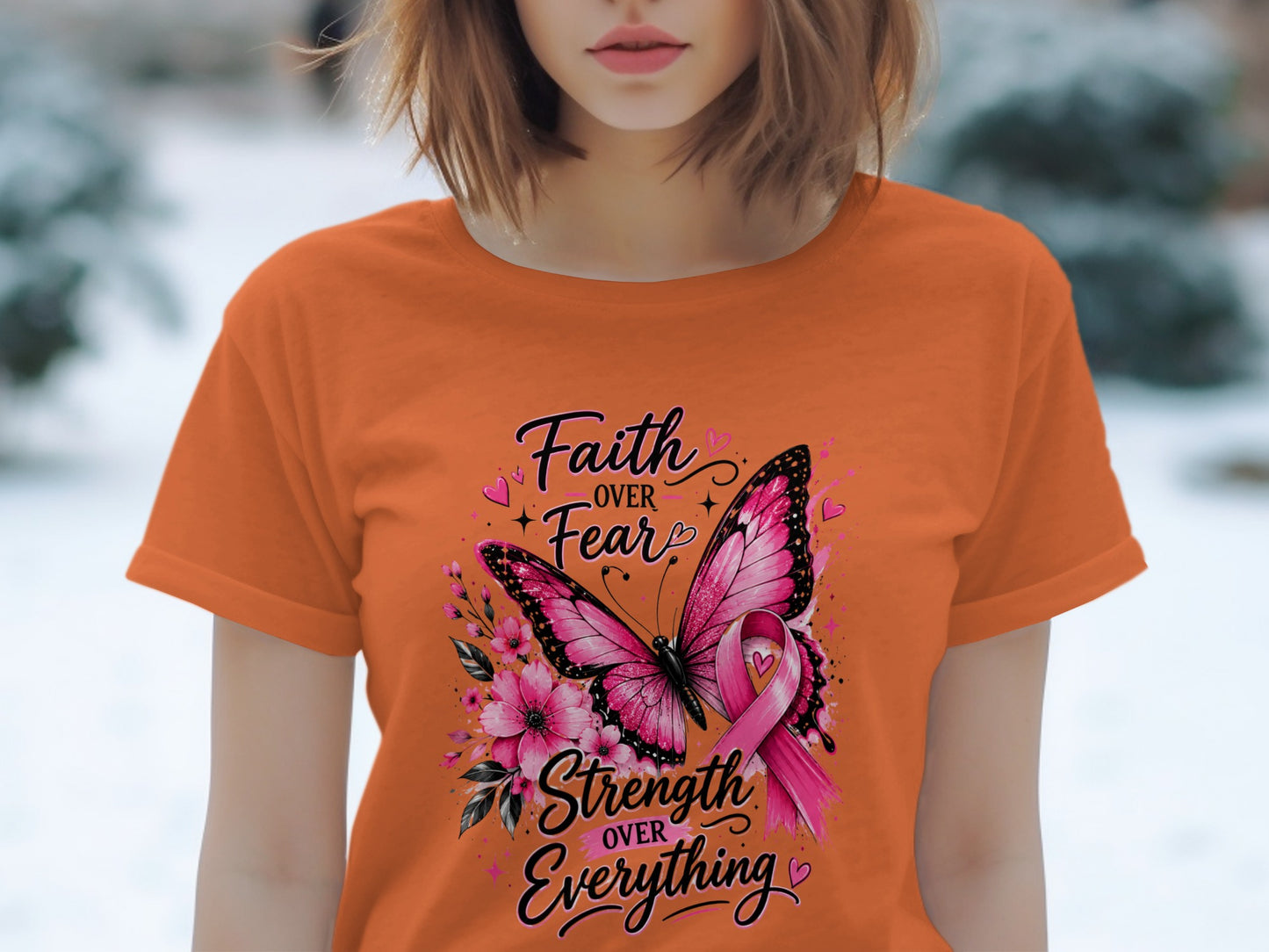 Orange t-shirt with "Faith Over Fear Strength Over Everything" text, butterfly, and pink ribbon.