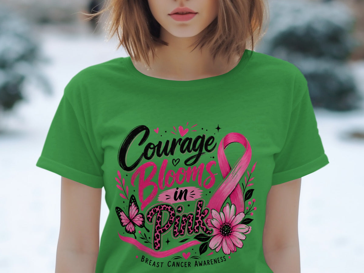 Green t-shirt with "Courage Blooms in Pink" and breast cancer awareness ribbon design.