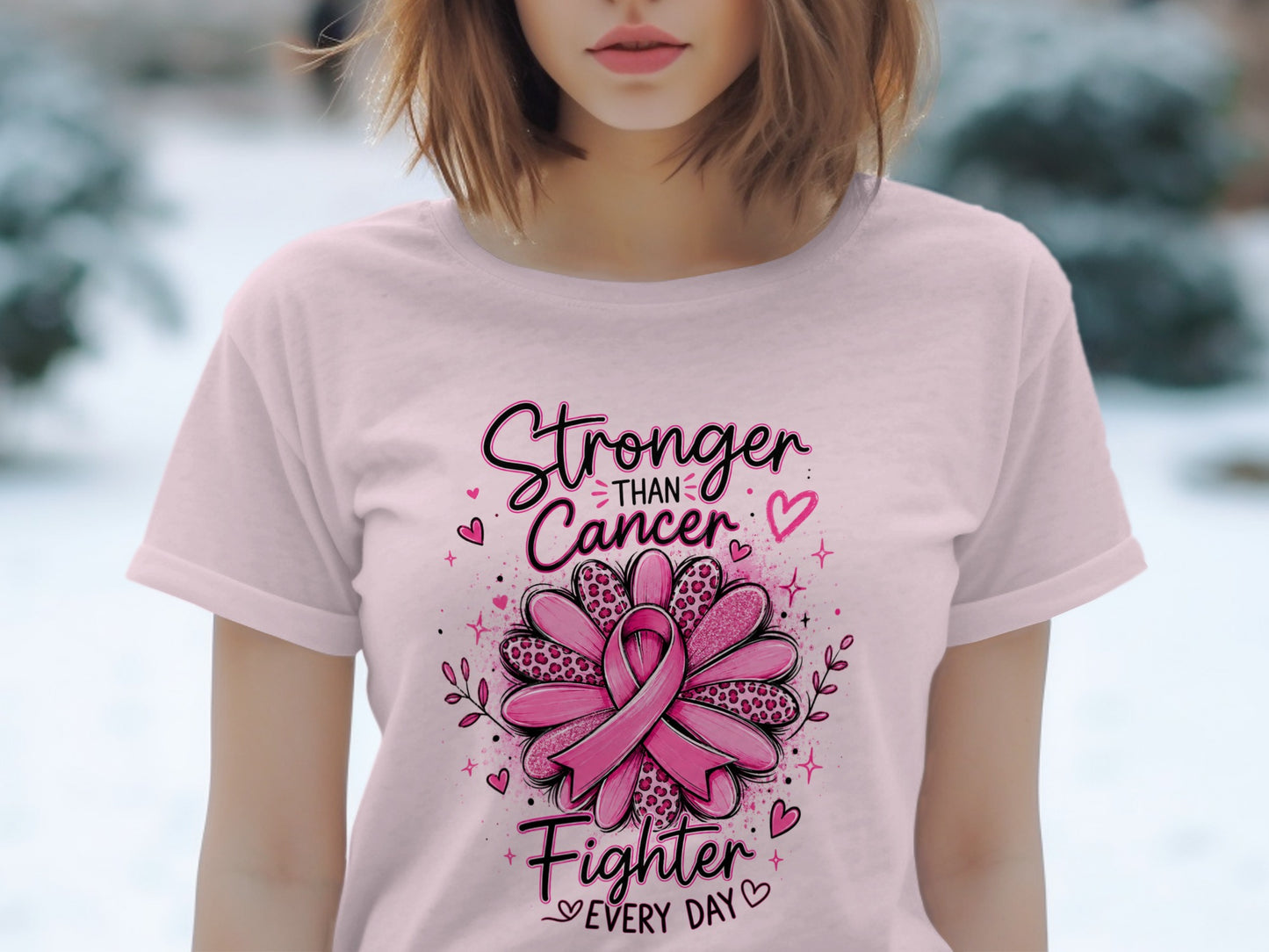 Pink t-shirt with "Stronger Than Cancer Fighter Every Day" text and pink ribbon design.
