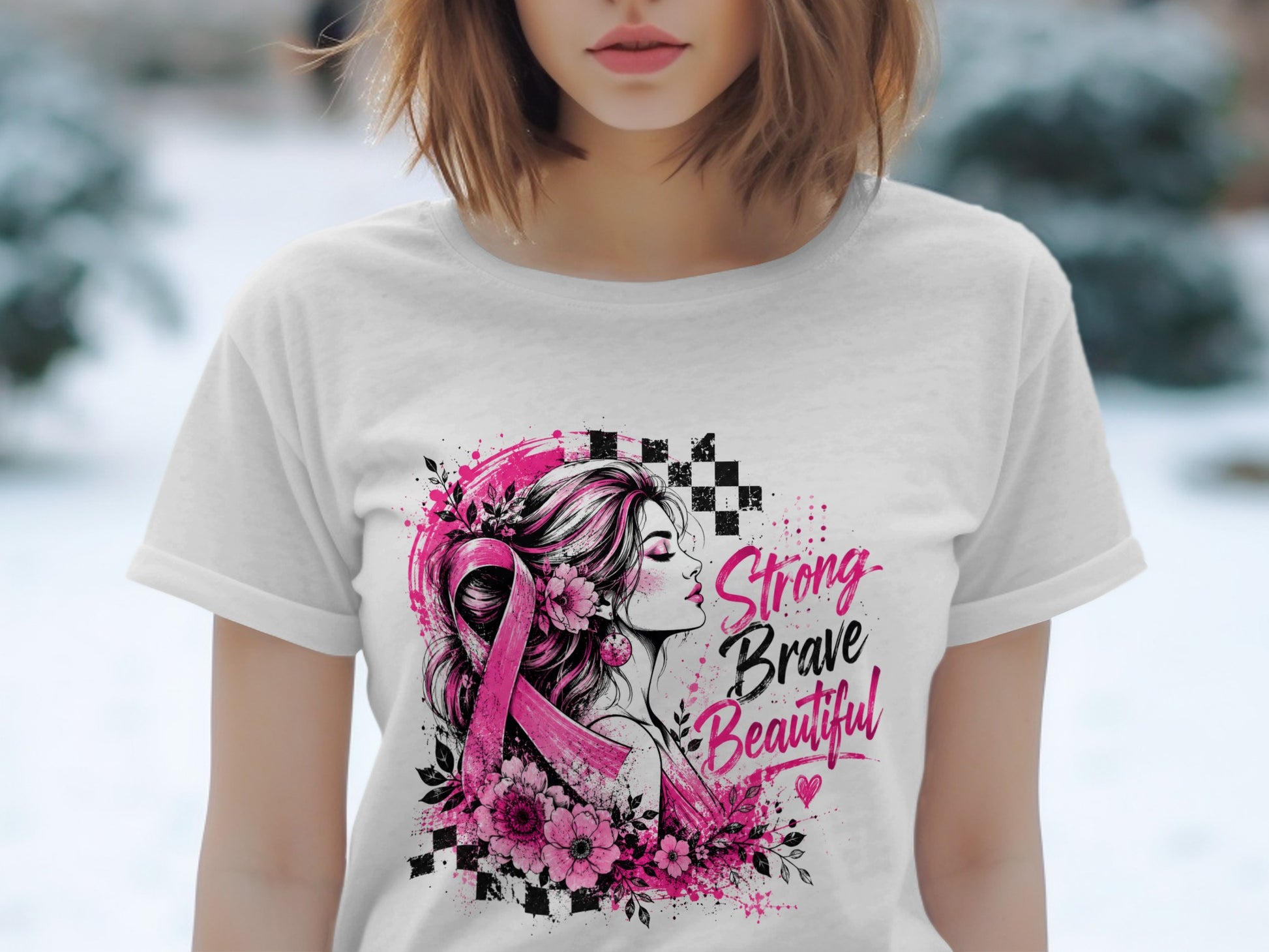 White t-shirt with pink ribbon, flowers, woman silhouette, and "Strong Brave Beautiful" text.