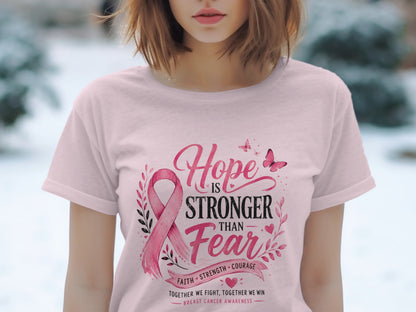 Pink t-shirt with "Hope Is Stronger Than Fear" breast cancer awareness design.