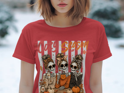 Skeleton women with heart sunglasses and pumpkins on a red shirt reading "Cozy Season."