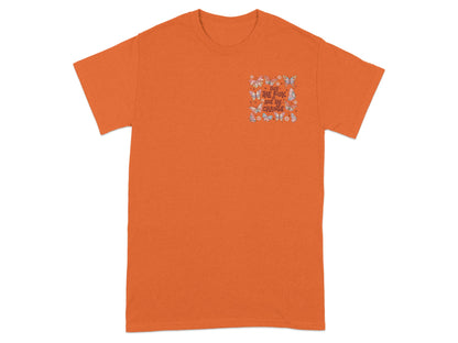 Orange t-shirt with a butterfly graphic and "Take the risk or lose the change" text.