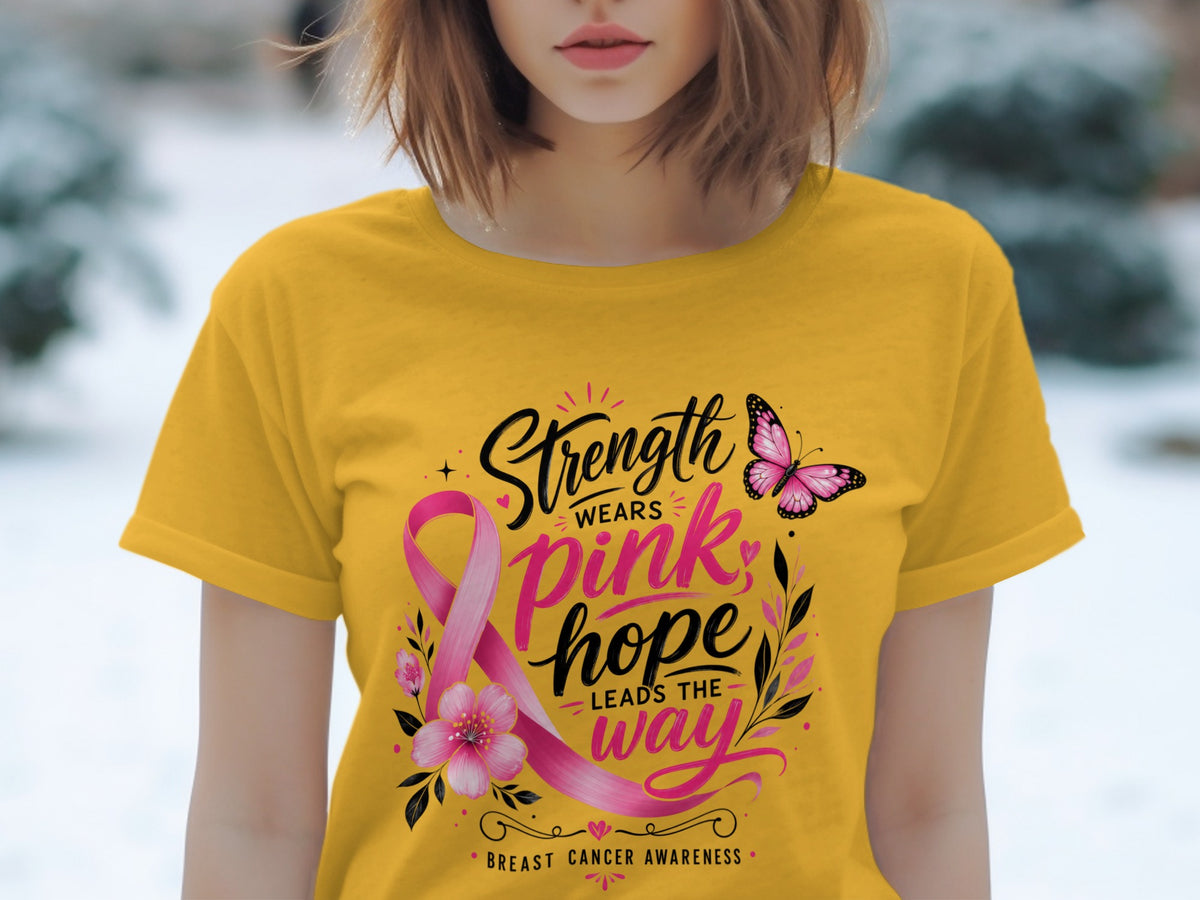 Yellow t-shirt with pink ribbon design, butterfly, and "Strength Wears Pink Hope Leads The Way" text.