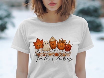 White t-shirt with a graphic of cute fall characters and "Fall Vibes" text.