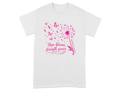 White t-shirt with pink dandelion, butterflies, ribbons, and text "Hope blooms, strength grows".