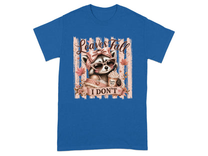 Raccoon in sunglasses with pink bow holding "Pumpkin Mood" coffee, text "Leaves Fall I Don't".