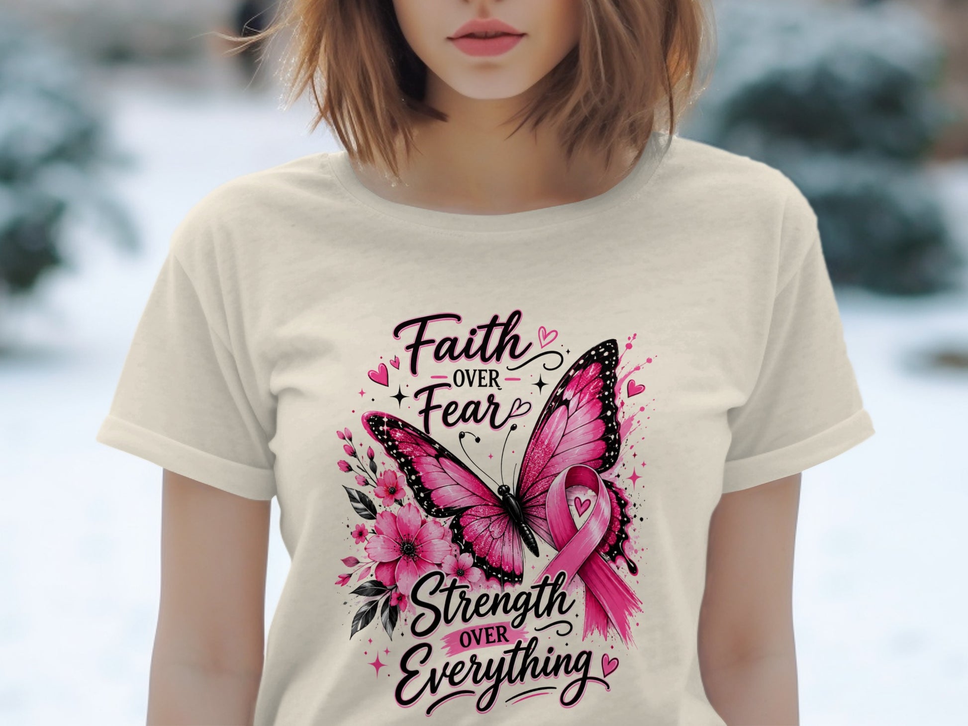 Cream t-shirt with pink butterfly, flowers, and text: "Faith Over Fear, Strength Over Everything."
