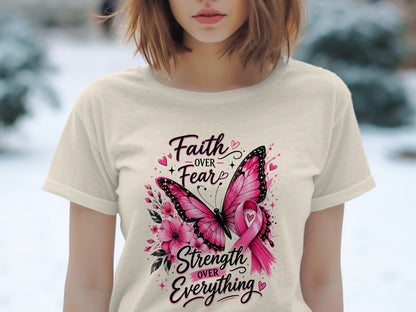 Cream t-shirt with pink butterfly, flowers, and text: "Faith Over Fear, Strength Over Everything."